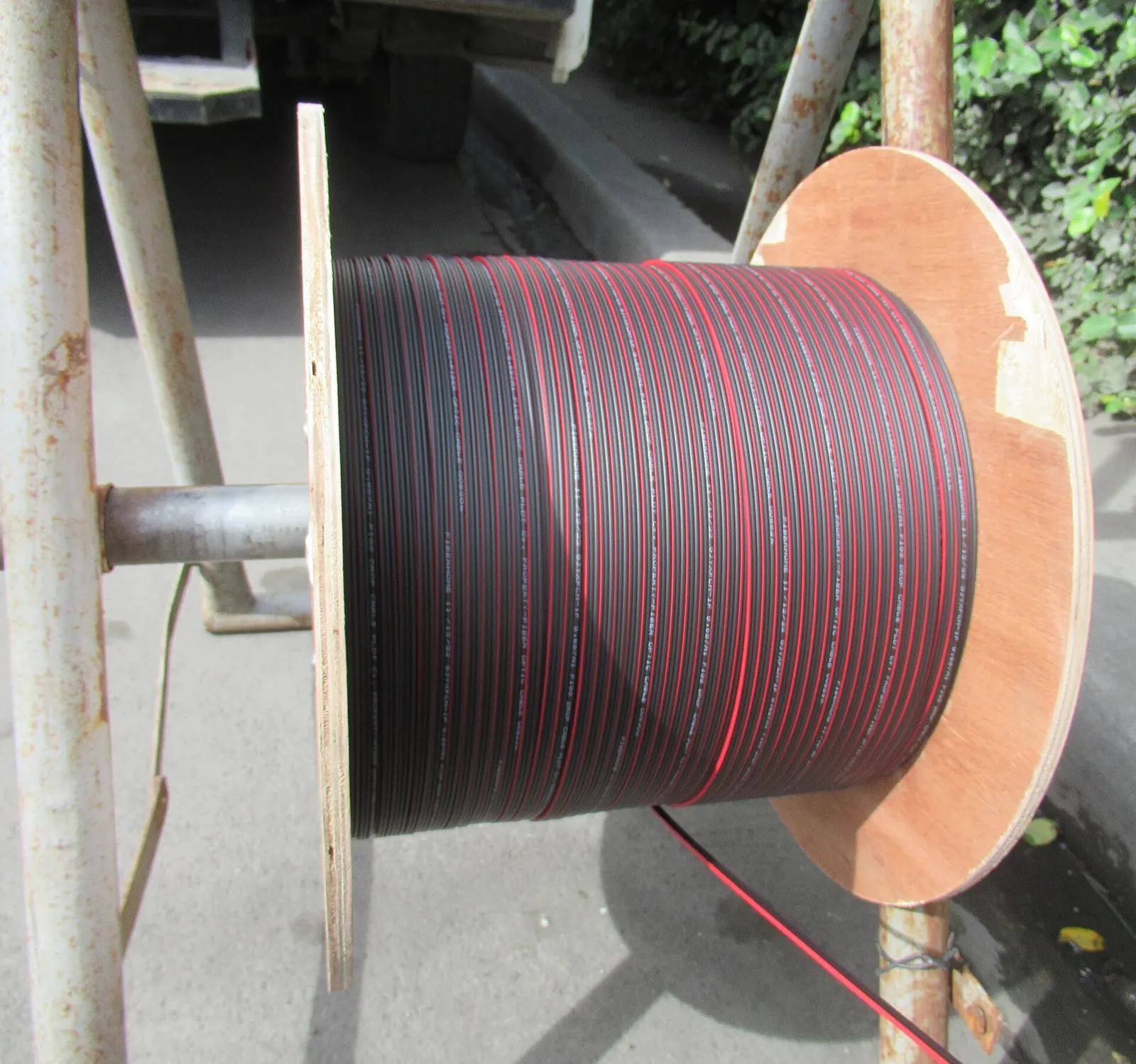 A drum of fibre-optic cable. Distance travelled through fibre is where latency comes from.