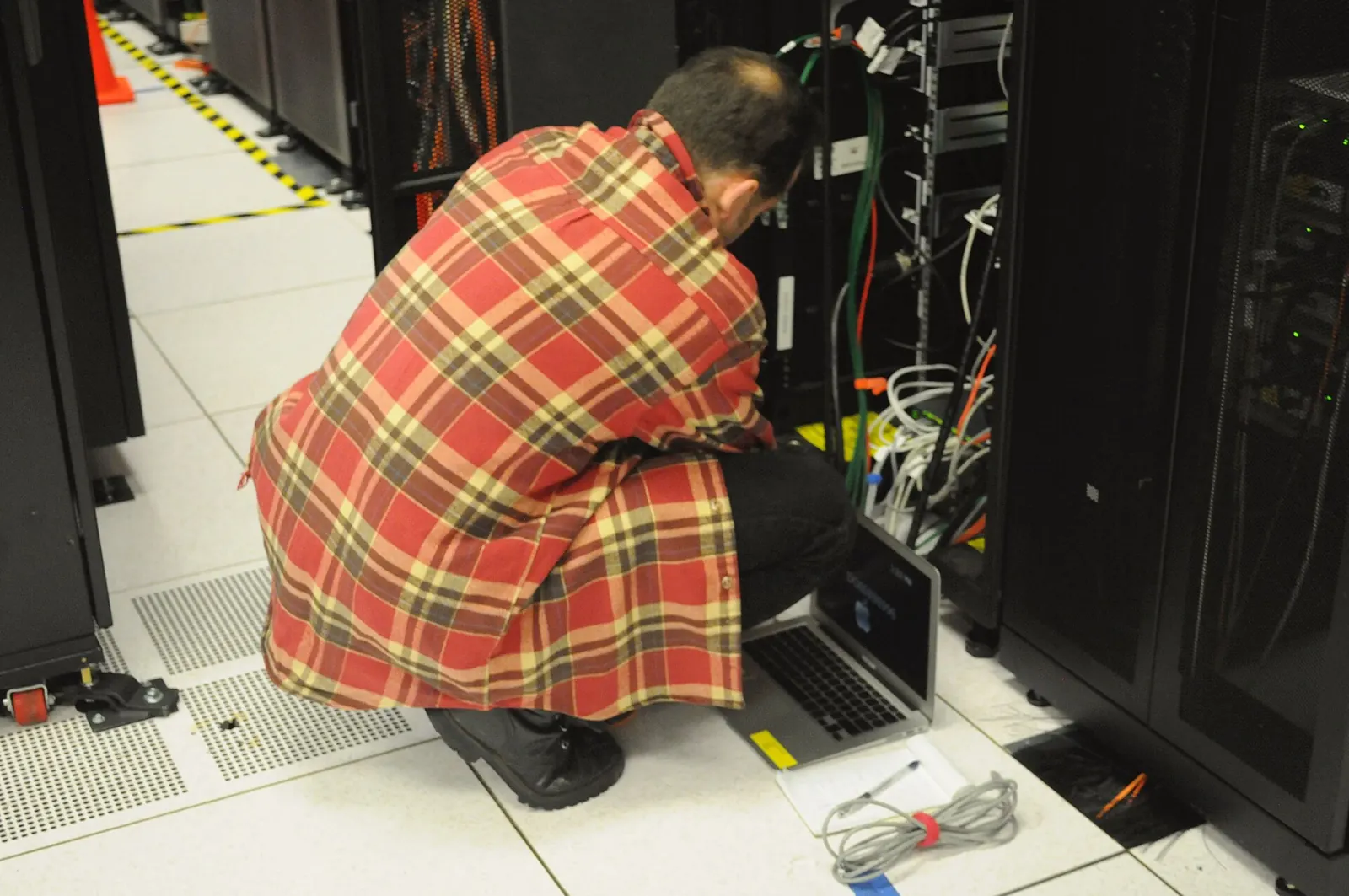 An engineer working on a server rack. Support quality comes down to people like this.